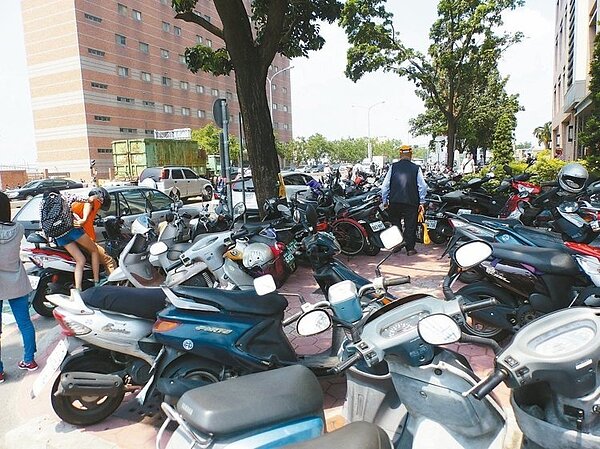 中山附醫文心南路、建國南路交叉口人行道，機車停放猶如迷宮，行人被迫側身、繞道而行。（ 記者趙容萱／攝影）