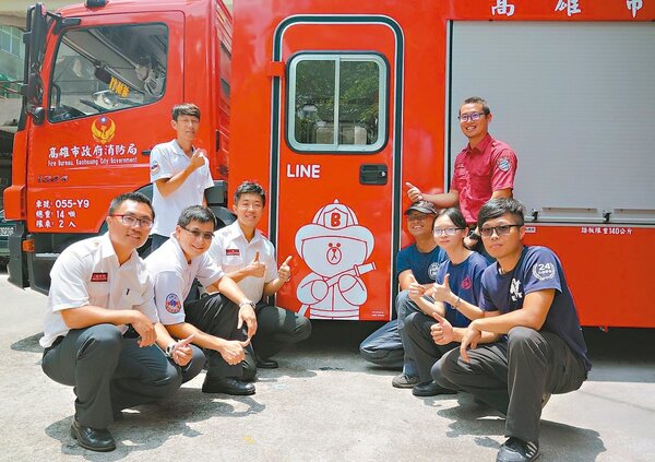 高市消防局前鎮分隊隊員們跟LINE TAIWAN捐贈消防車合照，消防車上有熊大穿消防衣圖案。 記者劉星君／攝影
