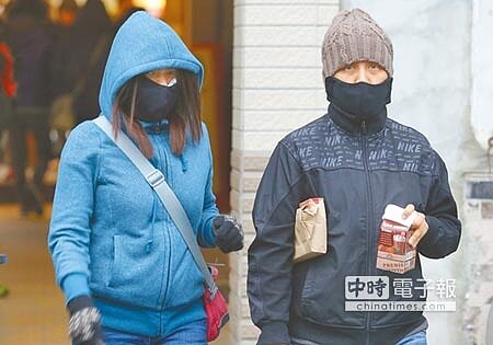 入冬最強寒流23日報到,夾帶水氣更是又濕又冷,路上行人又是大衣、又是圍巾、口罩等將自己包得緊緊的,氣象局表示周日氣溫會更低。(黃國峰攝)