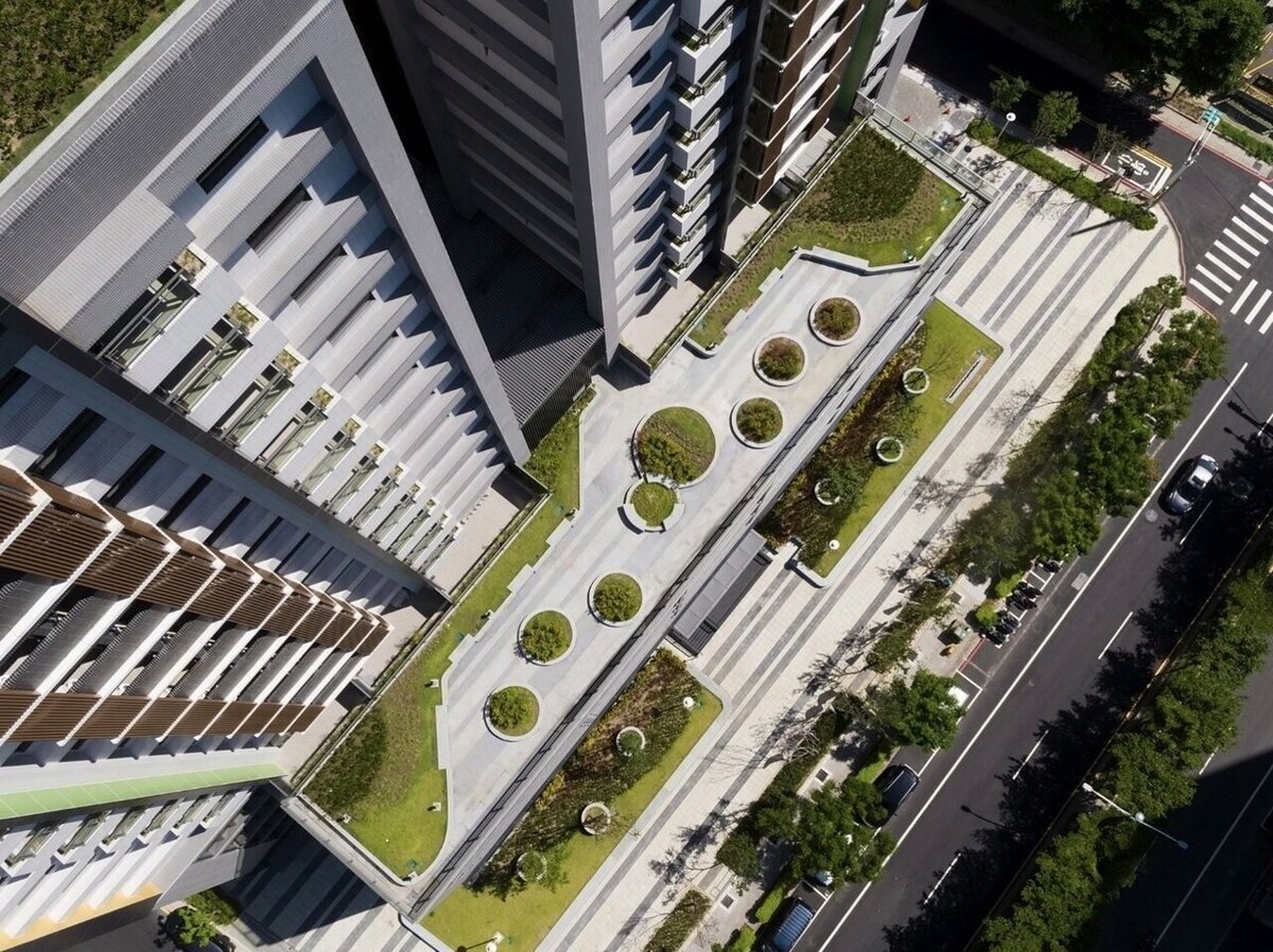 因應極端氣候,桃市府研擬推動「綠化共生建築」,相關法規預計本月報請內政部國土管理署核定,目標明年1月1日上路。圖為桃園中路二號社宅透過平台綠化設計,打造淨零環境。圖/桃園市都發局提供