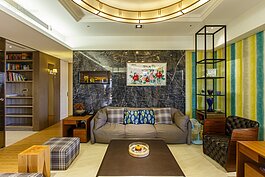 深色大理石牆面上，掛上了主人十分珍視的紅色湘繡。為了讓整體感覺更為一致而不會有重心偏斜的感覺。在湘繡左邊放了幾組琉璃作品，整個牆面立刻充滿濃濃的東方風情，而大理石牆面也不再讓人覺得冷冽。