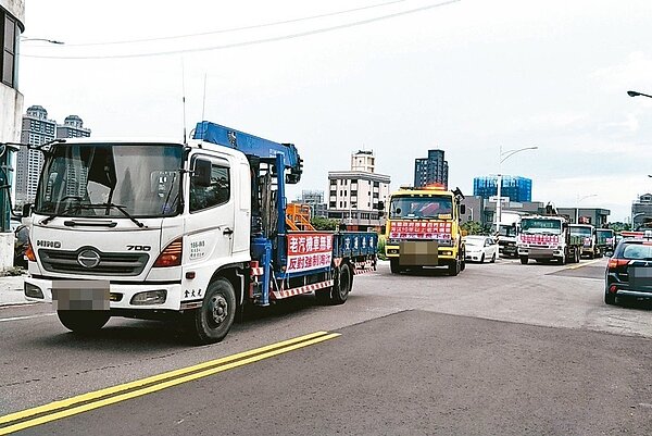 北部30輛老舊貨車在桃園市經國路集結拉起抗議布條,出發到桃園市政府與百輛老舊貨車會合,抗議強制淘汰老車行動。 記者曾增勳/攝影