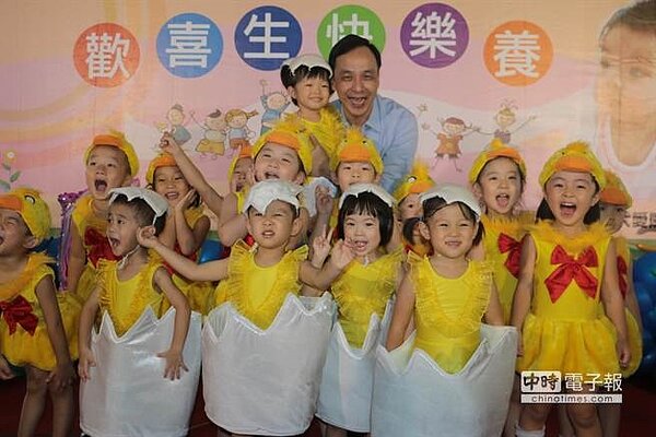 新北市長朱立倫今天上午出席新店區青潭公共托育中心啟用典禮,與小朋友開心合照。(孟祥傑攝)