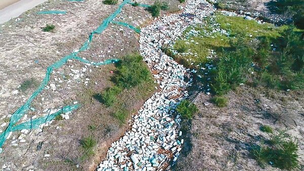 民眾在金門東北角船型堡附近空拍,在沙灘後面拍到長約200公尺「保麗龍河」。 記者蔡家蓁/翻攝