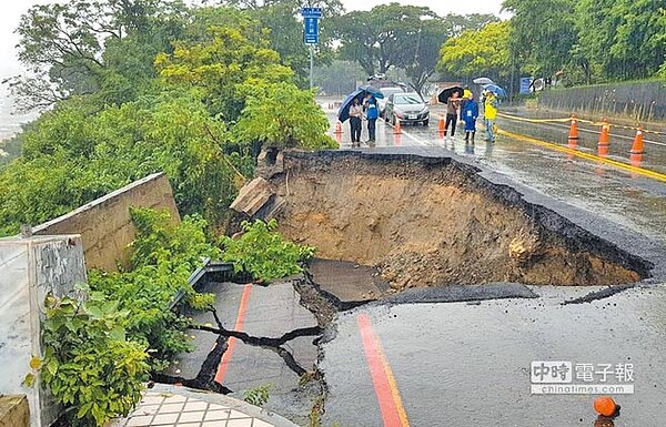 受西南氣流影響,高雄28日凌晨持續暴雨導致市區多處淹水,鼓山區萬壽山橋旁地基土石被淘空,路面塌陷一大塊。(圖/王錦河攝)