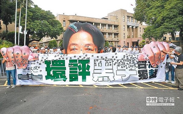 台灣健康空氣行動聯盟等環保團體3日在台北舉行「健康永續,藻礁永存」反空汙大遊行,參與民眾走到行政院外,用賴揆貼紙貼在行政院長賴清德的人像橫幅上抗議。(姚志平攝)