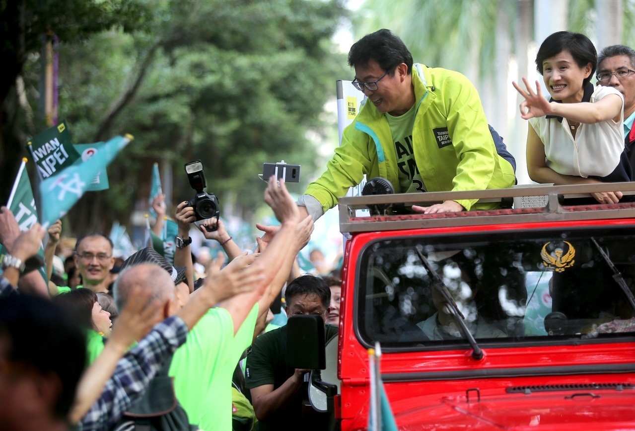 民進黨台北市長候選人姚文智（右二）在文化部長鄭麗君（右一）陪同下繞行北市街頭，沿途與民眾擊掌。 記者高彬原／攝影