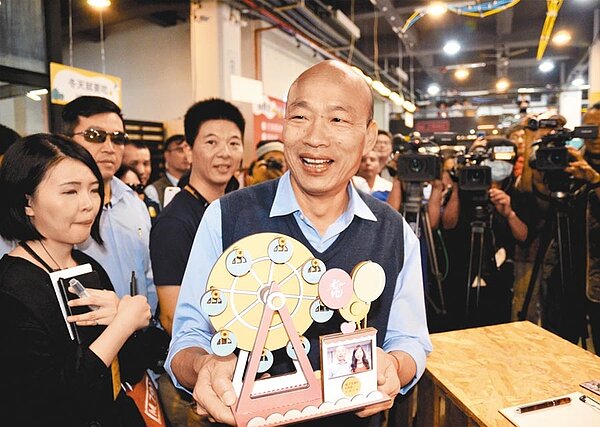 高雄市長韓國瑜力拚愛情產業鏈,喧騰多時的愛情摩天輪開發案有譜了!高市府30日召開說明會,約10多家廠商與會。圖為韓國瑜2月笑捧手作的愛情摩天輪,上面有他與女兒韓冰的照片。(本報資料照片)