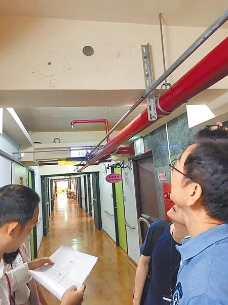 台北市議員李慶元(著藍衣者)7日前往北投浩然敬老院,了解氯離子檢驗超標的梁柱位置及狀况。(陳俊雄攝)