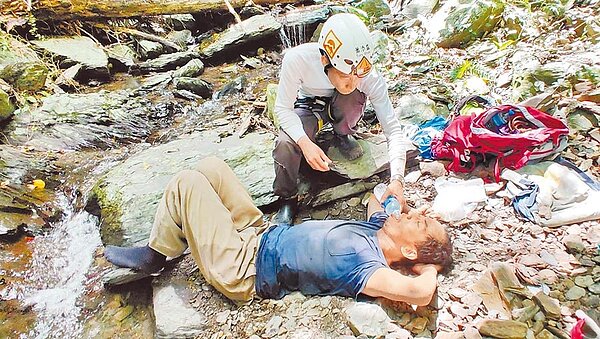 民間搜救隊員蕭添益第一時間發現失聯10天的屏安醫院副院長楊欣正，立刻協助補充水分。（山友提供／林和生屏東傳真）