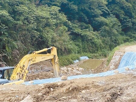 新莊十八份坑溪流出氣味難聞的滾滾黃泥及大量垃圾，施工人員將垃圾用帆布蓋上後繼續施作，強降雨時垃圾沖入溪流。（戴上容攝）