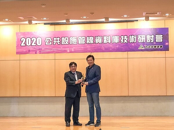 新北市政府共同管線資料庫表現亮眼,六連霸榮獲全國第一名,今天由營建署長吳欣修(左)頒將表揚,新北市副秘書長朱惕之代表領獎。