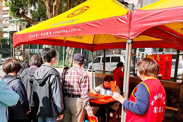 康寧里由鄭秀鳳里長帶領書法老師們為民眾揮毫,吸引許多里民現場排隊領取。圖/永慶房產提供