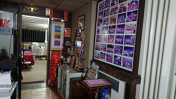 葫洲里辦公室玄關旁,放滿各式里評鑑獎盃與活動照片。圖/徐子為攝