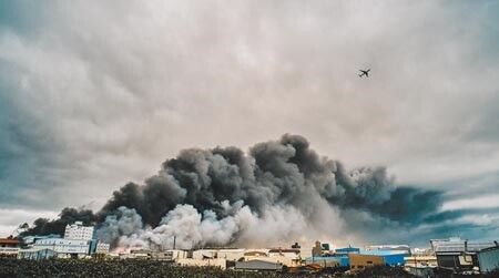 旭富工廠爆炸後引發的一大片濃濃黑煙直竄天際，盤踞桃園國際機場北側跑道上，班機只好穿越濃煙起飛。（郭吉銓攝）