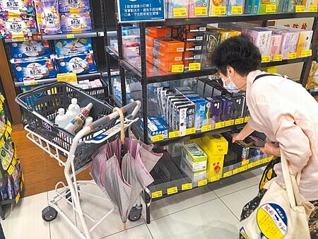 疫情升溫,不少民眾搶購民生和防疫物資,業者也積極備貨,圖為全聯中正延平店民眾選購口罩。(吳松翰攝)