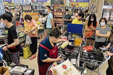 疫情再度升溫,雙北升為三級防疫警戒,15日中央開記者會後,賣場立刻湧入大批民眾搶購物資。(鄧博仁攝)