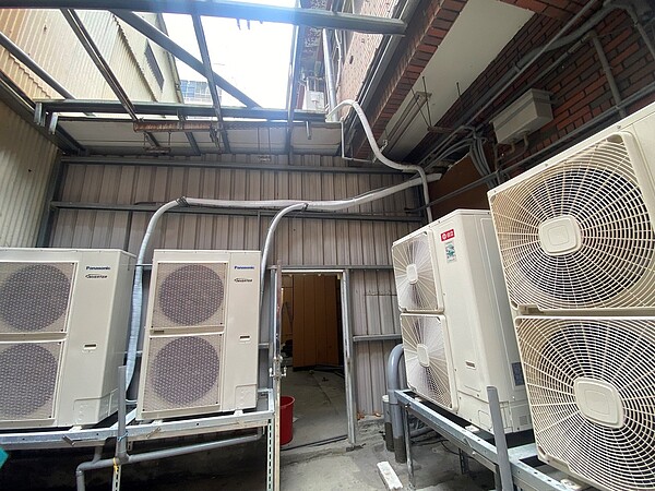 「金興實業大樓」1樓兩戶打通開設便利商店,確有搭蓋違建占用法定空地及防火巷情事。圖/台北市政府提供