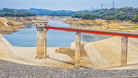 台灣面臨氣候危機,乾旱屢屢造成水庫告急,圖為新竹寶二水庫58米高的取水塔,今年5月時乾到裸露見底。(本報資料照片)