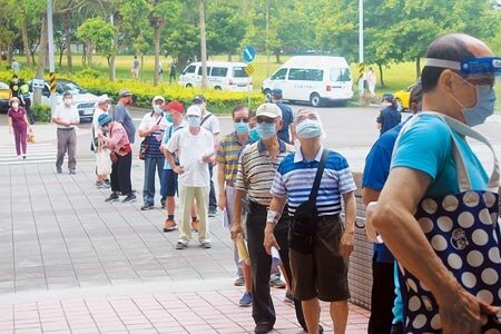 武漢國中站4日上午出現排隊人潮,接種站指出約上午8時因過卡系統有塞車情形,才導致排隊人潮,並表示過卡問題已有改善,接種效率也逐步回升。(蕭靈璽攝)