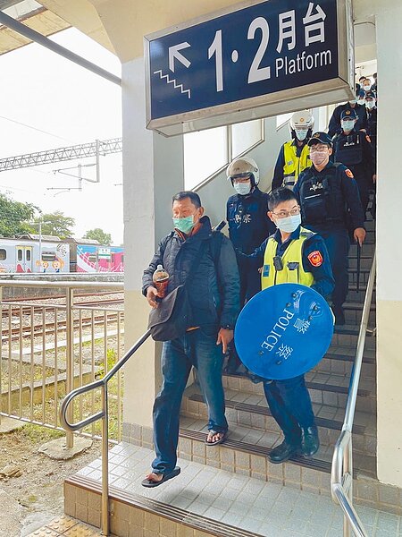 薛姓男子(前左)昨天搭乘台鐵3167次區間車南下,在抵達嘉義縣水上鄉南靖車站時高喊要殺人,鐵路警察局嘉義分駐所獲報後趕往,將薛帶回偵訊。圖/讀者提供