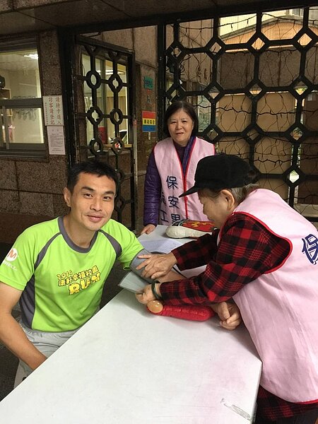 健康守護志工，提供民眾量血壓的服務。圖／許承煬提供