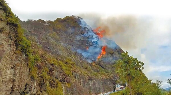 花蓮豐濱鄉親不知子海上古道上方山壁，24日疑因火燒蜂窩時，海風助長火苗，火勢快速蔓延，幸在空勤出動直升機灌救下，順利控制火勢。圖／花蓮縣消防局第二大隊提供