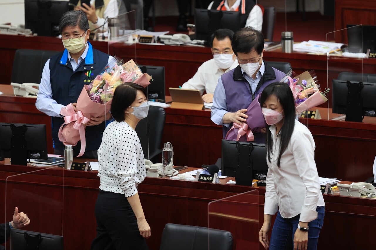 台北市議員王鴻薇（左前）、闕枚莎（右前）上午在市議會質詢前，先獻花給台北市消防局長吳俊鴻（左後）與台北市衛生局長黃世傑（右後），感謝這些基層人員的辛苦付出。記者蘇健忠／攝影 