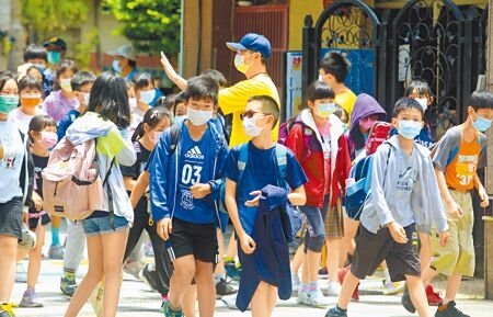 
新冠肺炎疫情嚴峻，台北市教育局宣布高中以下各校啟動1周遠距教學。圖為國小學童18日放學情形。（張鎧乙攝）
