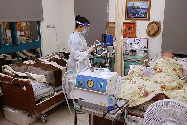 國內長照安養機構接連爆發嚴重群聚感染。圖為長照機構工作人員穿著全套防護裝備照顧長者。示意圖，非當事安養機構。聯合報系資料照片