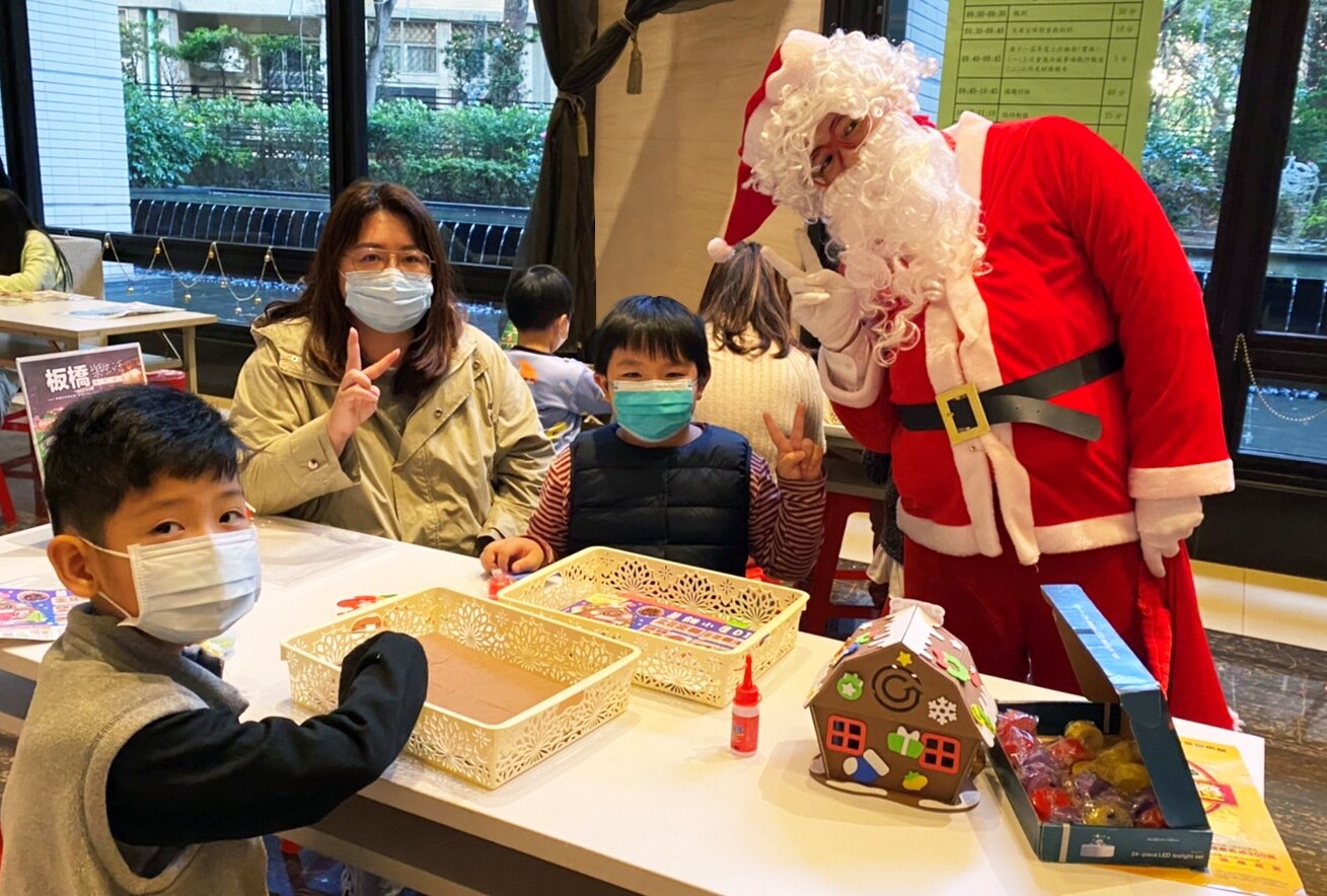 永慶房屋化身聖誕老公公,到社區大廳發糖果祝福大小朋友聖誕快樂。圖/永慶提供
