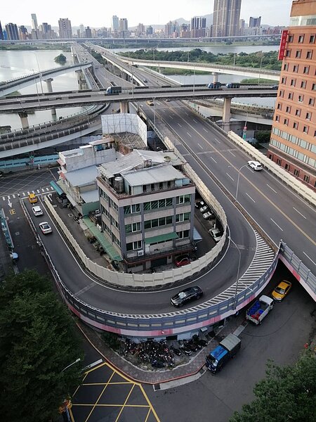 中興橋銜接環河南路引道轉彎處內包圍著民宅，影響居住品質，居民盼能廢除引道。圖／菜園里長蔡蕙而提供