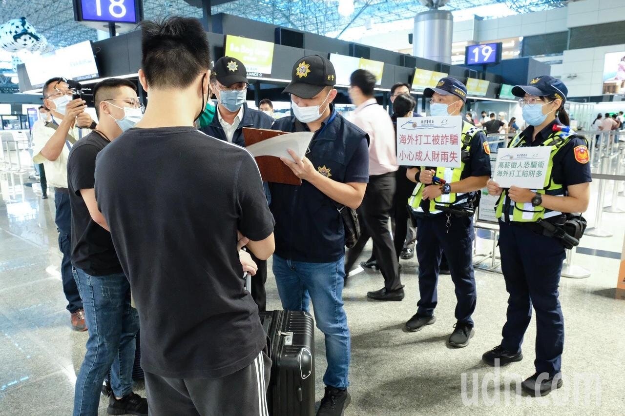 為防止民眾遭誘騙至柬埔寨,航警局員警持手牌宣導。 記者黃仲明攝影/聯合報系資料照片