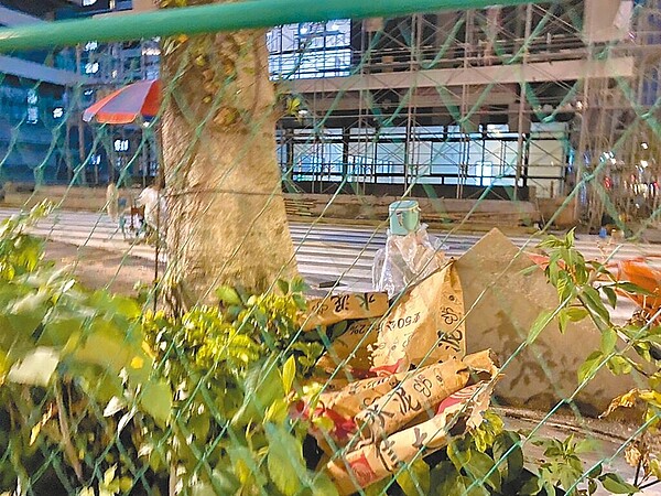 台北市內湖行善社會住宅被許多市民投訴,施工基地內有人亂丟建材及垃圾,在圍籬外就可看到水泥堆滿地,隨處也可見高壓磚、鋼筋、水溝蓋板壓在樹上。(台北市議員陳怡君研究室提供/張芷瑜台北傳真)