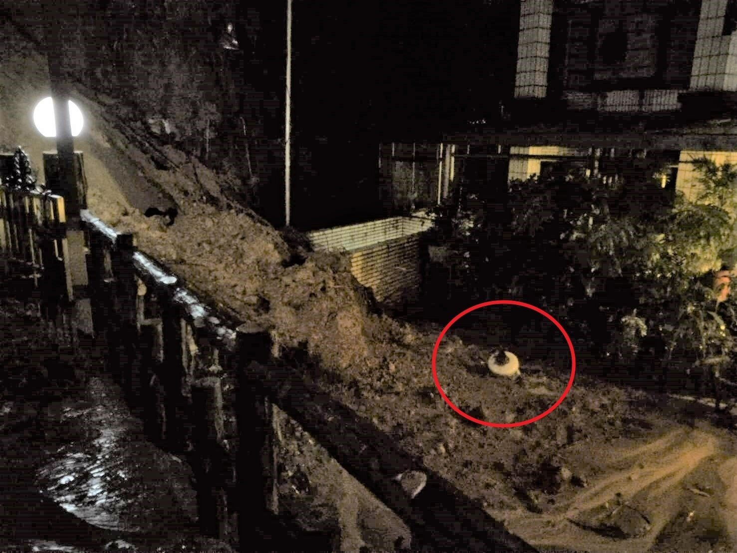 新北市汐止區伯爵街6巷旁山坡昨發生土石流,土石中有疑似電塔礙子(紅圈處)設備。記者邱瑞杰/攝影