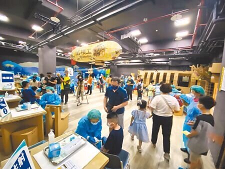 設置在科博館紙箱王餐廳的中榮科博兒童疫苗接種站，環境中布滿紙箱製作的藝術品，更有大型恐龍，讓小朋友可以在舒適的場域接種。（馮惠宜攝）