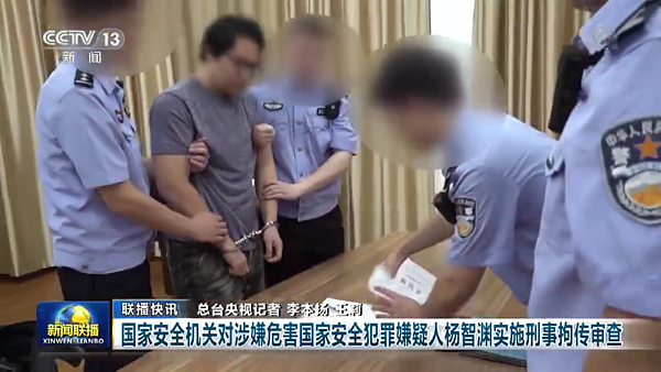 央視曝光台灣人楊智淵(左)上銬畫面。圖/取自央視