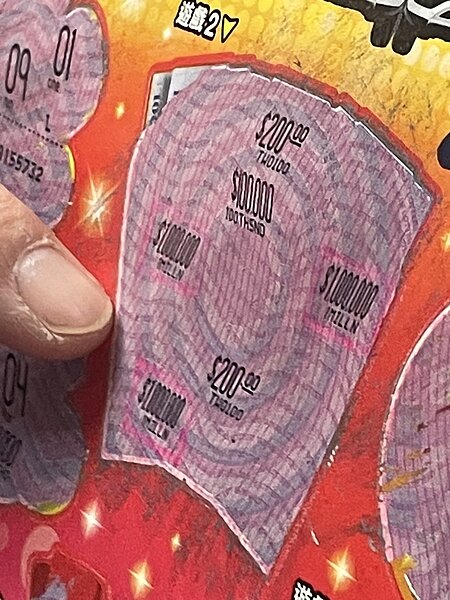 高雄林先生與同事共10人集資「2000萬超級紅包」刮刮樂,連續兩年幸運刮中100萬元。記者徐如宜/攝影