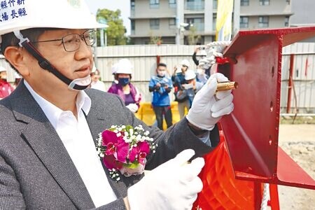 新竹縣長楊文科參加竹北勝利國中新建校舍上梁典禮，並在梁上栓上金色螺絲祈福。（邱立雅攝）