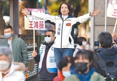 國民黨台北市第三選區立委補選候選人王鴻薇(中)26日早上在路口向上班的民眾拜票尋求支持。她曾拋出 「還稅於民」的政見,認為此事早就該做。(季志翔攝)