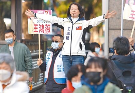 
國民黨台北市第三選區立委補選候選人王鴻薇（中）26日早上在路口向上班的民眾拜票尋求支持。她曾拋出 「還稅於民」的政見，認為此事早就該做。（季志翔攝）
