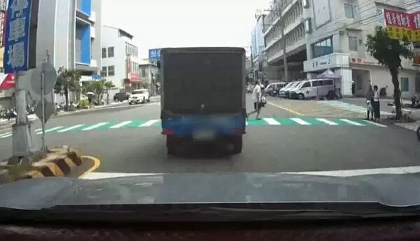 台中沙鹿區光田醫院前路口,有行人穿越道,沒有號誌,一名行人走在斑馬線上,小貨車停車禮讓,機車沒讓,差點撞上行人。圖/民眾提供