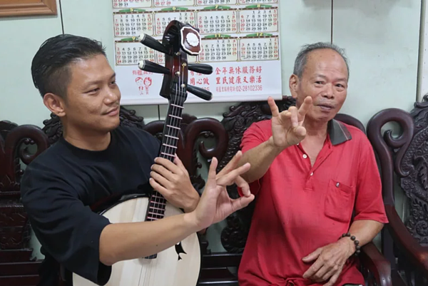 82歲的許阿伯（右）跟著老師練習京劇身段。圖／新北市社會局提供