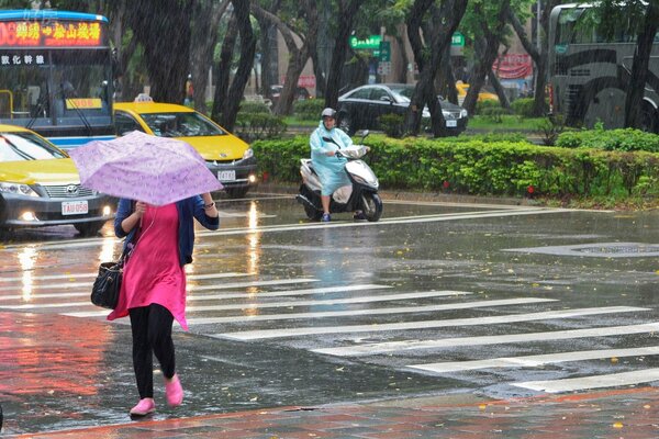 康芮颱風來襲,下雨不斷,路人緊抓雨傘抵擋風雨,豪大雨特報,西北雨,颱風雨。(好房News記者 陳韋帆/攝影)