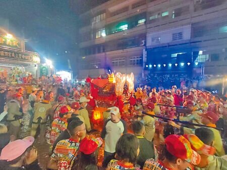 大甲媽祖鑾轎深夜返抵鎮瀾宮附近,現場擠滿信徒,鞭炮、鑼鼓聲喧天,鑾轎在眾人擁簇下緩慢前進。(潘虹恩攝)