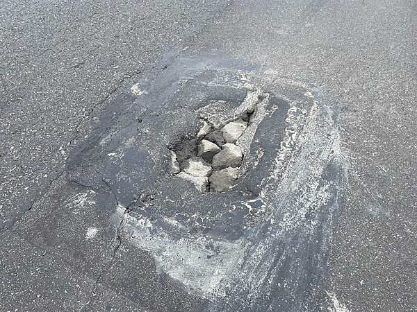 成功橋為連接內湖、南港的重要樞紐,有許多通勤人口會使用。台北市議員李明賢發現,2019年拓寬完成後,路面出現大小坑洞,危害騎士安全。(台北市議員李明賢提供/劉彥宜台北傳真)