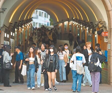 受到半導體、資通訊產業榮景影響,2024年度百大熱門大學科系資工、電機和法律名列前茅。圖為世新大學學生們魚貫步出校門。(本報資料照片)