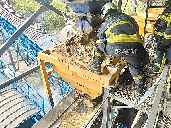 台中市清水區1家工程行老闆在維修混土機具時,遭突掉落的砂土掩埋,消防員獲報後到場以鏟子清除土石協助脫困,將失去生命跡象的李老闆送醫,急救救回1命。圖/台中市消防局提供