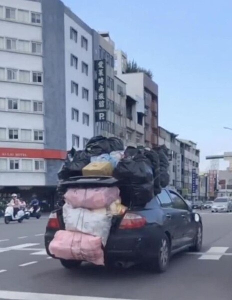 台中市西區五權路、英才路在近日被網友目擊，有輛轎車堆疊大量雜物，甚至後照鏡也已掉落未維修。圖／摘自社會事新聞影音