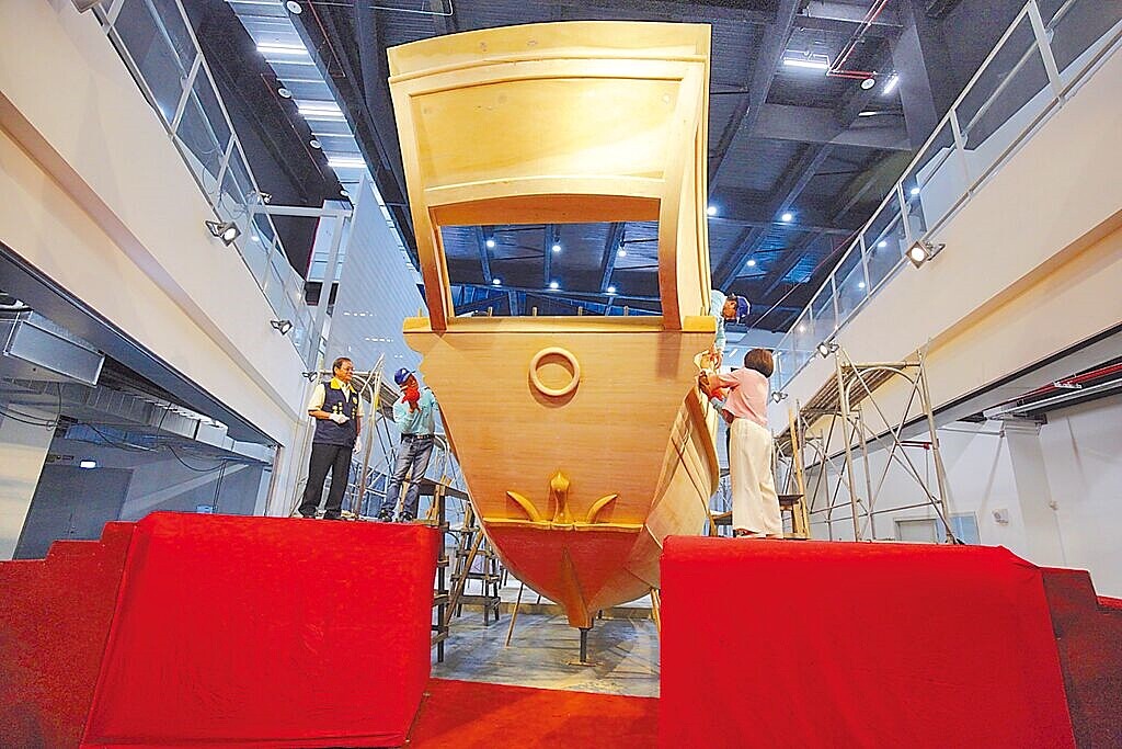 王船文化館典藏王船「安龍目」儀式由屏東縣長周春米(右)與東隆宮董事長潘慶士(左)持槌將龍目固定於船首。圖/屏東縣政府提供